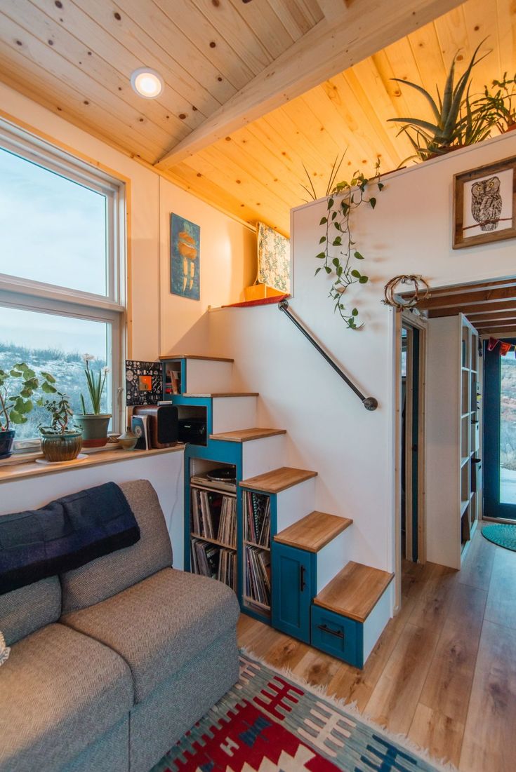 a living room filled with furniture next to a window