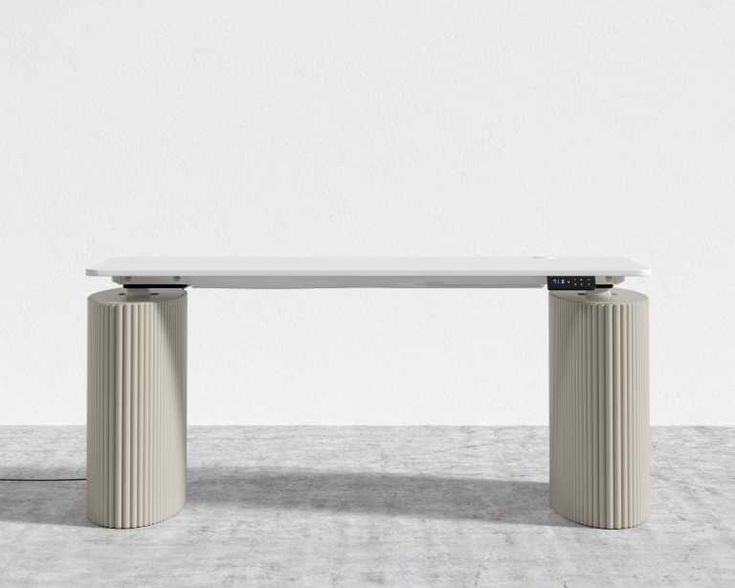 a white table sitting on top of a cement floor