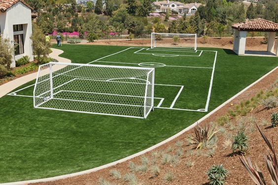 an aerial view of a soccer field and goal