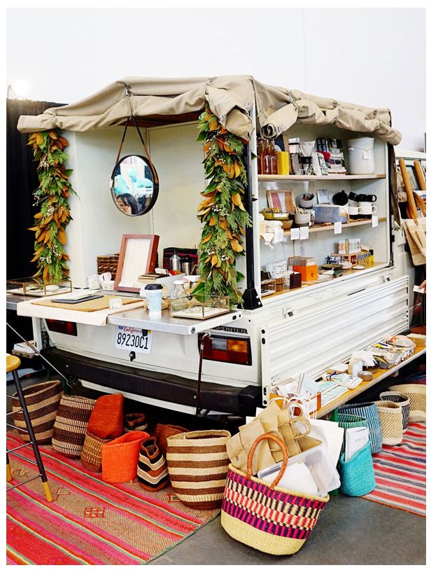 a food truck parked on the side of a road with lots of baskets in front of it