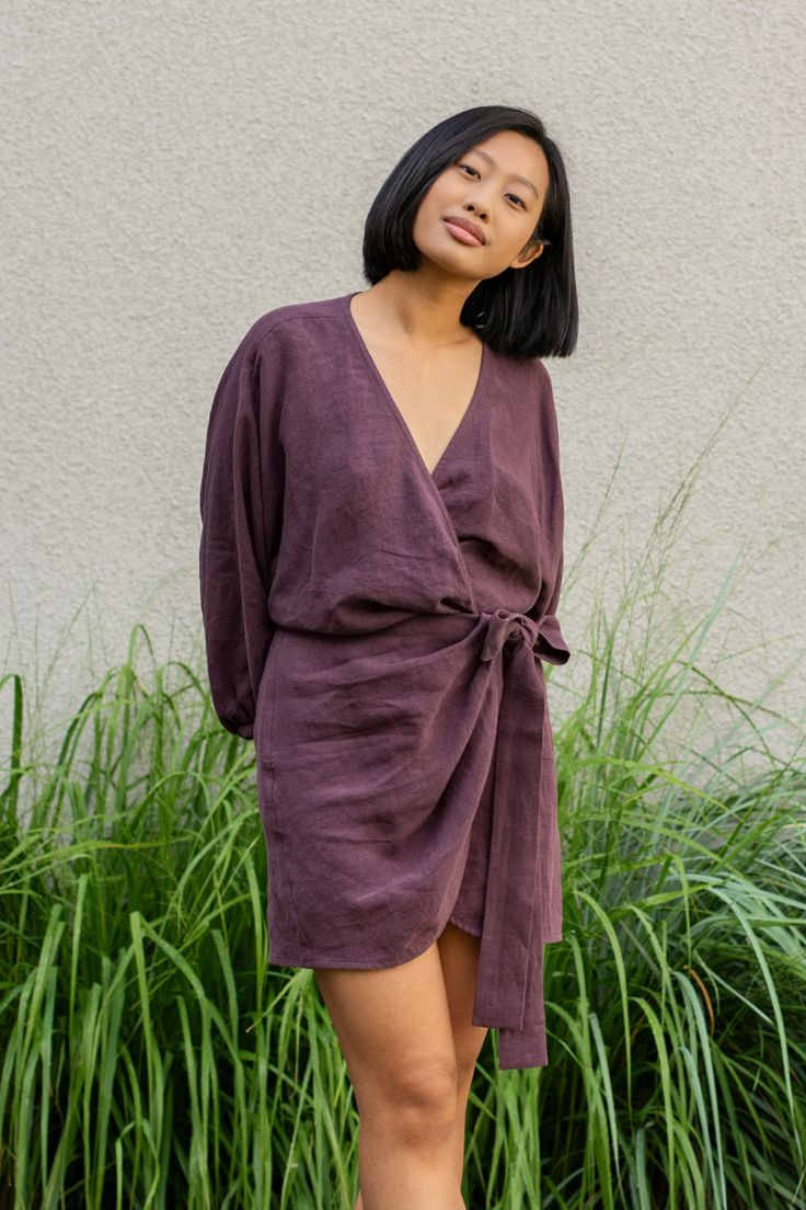 Woman wearing Linen wrap tulip hem dress Daisy in shadow purple color V-neck Tie Waist Dress For Day Out, Belted V-neck Mini Dress For Day Out, Fall V-neck Midi Dress With Tie Waist, Chic V-neck Midi Dress With Tie Fastening, V-neck Tie Waist Dress For Daywear, Spring V-neck Belted Dress For Date Night, Chic V-neck Belted Dress For Day Out, Chic Knee-length Mini Dress With Tie Waist, Mini Dresses With Tie Fastening For Daywear