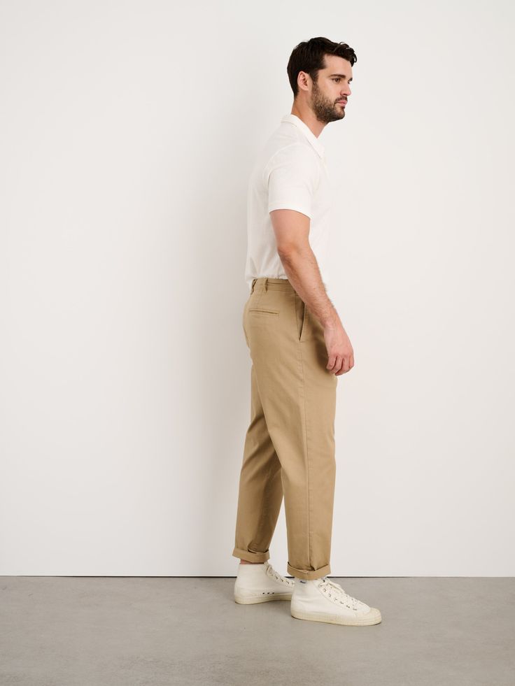 Our signature pleated chino is made from a slightly stretchy, mid-weight fabric. Garment-dyed for rich, nuanced color. Subtle front pleats for extra roominess (= comfort). Zip-fly closure, coin pocket, and "X" belt loop at the back. Due to the nature of the garment-dyeing process, slight variations in color should be expected. The fit's slightly cropped with a longer rise and relaxed throughout the leg. For anyone 5’9" and under, we suggest ordering the regular inseam. For anyone taller than 5'9 Chino Cotton Twill Work Pants With Straight Hem, Chino Cotton Twill Work Pants With Belt Loops, Chino Cotton Twill Chinos For Work, Workwear Chinos In Chino Cotton Twill, Workwear Chinos With Standard Cut Leg, Standard Cut Leg Chinos For Workwear, Cotton Selvedge Pants With Tapered Leg, Cotton Selvedge Tapered Leg Pants, Selvedge Cotton Tapered Leg Pants