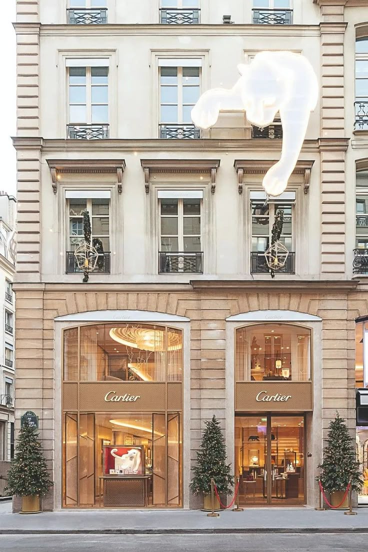 a store front with christmas decorations on the windows