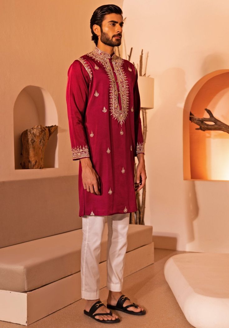 Elevate your style with the Crimson Red Embroidered kurta set. This stunning Red kurta features intricate embroidery, including beads, mirrors, and thread work. With a chinese collar and detailing on the armholes, this kurta is perfect for Sangeet, Mehendi, or as a wedding guest. The set includes white straight fitted pants with buttoned closure, ankle length and side pockets. Composition : Padma Silk Care: Dry Clean Only and Vacuum Storage This product can be customized for sleeves, length and colour Delivery : 4-6 weeks as the product is hand crafted. Check Size Guide or choose MySize for free customisation (All Sizes above XL can be made at 15% additional cost) For more information and sizes please contact fabiliciousfashion@gmail.com or visit our Copenhagen studio. About the Designer : Red Kurta With Resham Embroidery For Transitional Season, Red Resham Embroidered Kurta For Transitional Season, Red Raw Silk Kurta For Navratri, Transitional Red Raw Silk Kurta, Red Silk Kurta With Resham Embroidery, Festive Red Traditional Designer Wear, Red Sets With Mirror Work For Eid, Red Raw Silk Kurta With Traditional Drape, Red Straight Kurta With Mirror Work