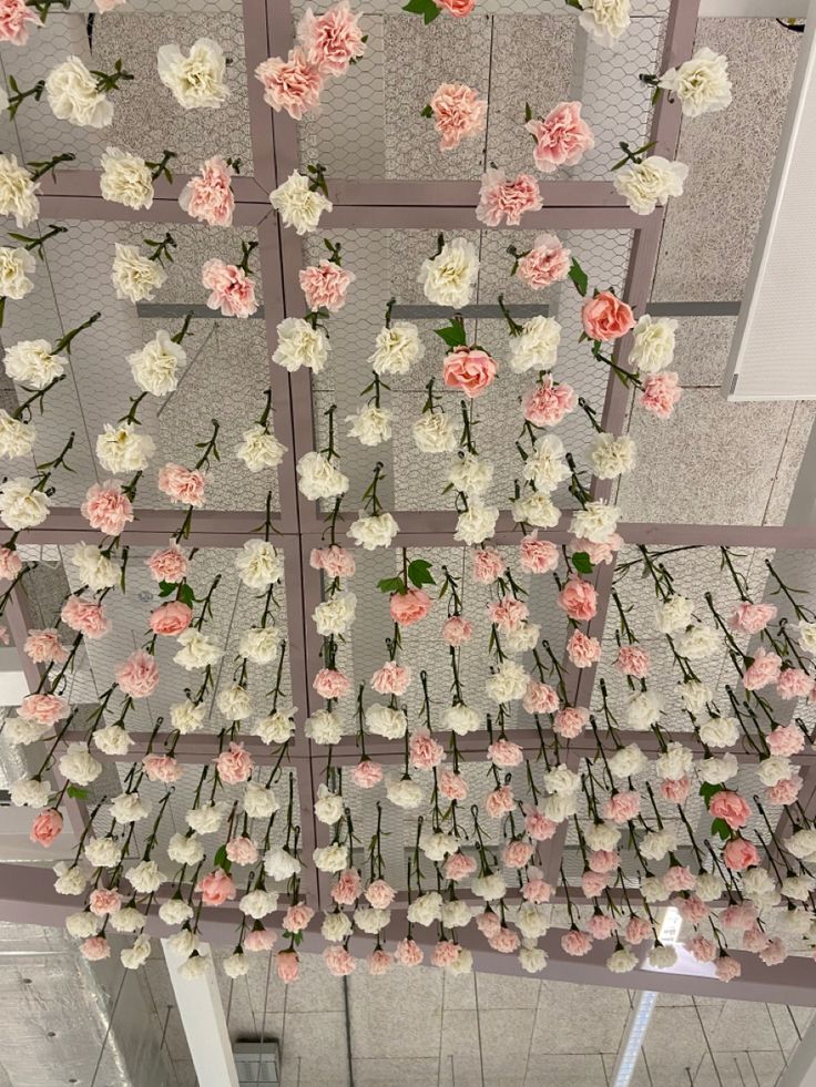 flowers hanging from the ceiling in a building