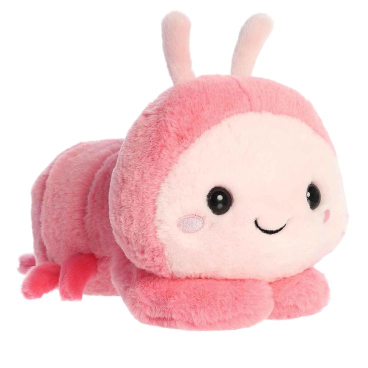 a pink stuffed animal laying on its side