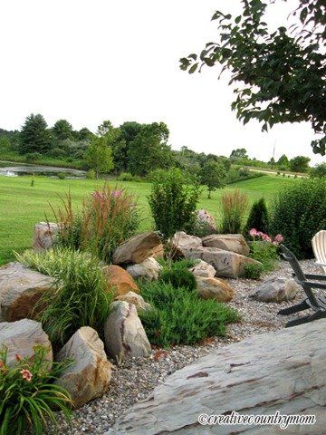 a chair sitting on top of a rock covered field