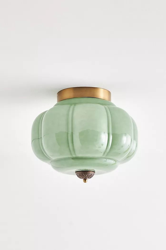 a green light fixture hanging from the ceiling