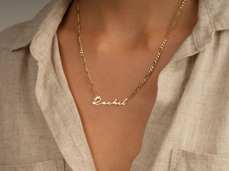 This 14k solid gold name necklace is made from a dainty, yet chic flat figaro chain. Its beautiful finish shines against your skin to accentuate your beauty. Don't forget to choose the best length that works for you! FEATURES • Material: 14k Solid Gold (Stamped 14K for authenticity) • Color Options: Yellow Gold • Chain Style: Flat Figaro Chain • Chain Width: 3.00 mm • Clasp Type: Lobster Clasp • Available Lengths: 14", 15", 16", 17", 18", 19", 20" For custom lengths feel free to contact us. We c Elegant Personalized Curb Chain Necklace, Elegant Necklace With Curb Chain For Personalized Gift, Elegant Curb Chain Necklace For Personalized Gift, Elegant Gold Chain Necklace With Custom Name, Minimalist Curb Chain Necklace For Anniversary, 14k Gold Figaro Chain Nameplate Jewelry, Figaro Chain Nameplate Jewelry For Anniversary, Figaro Chain Nameplate Necklace As Gift, Elegant Nameplate Curb Chain Necklace