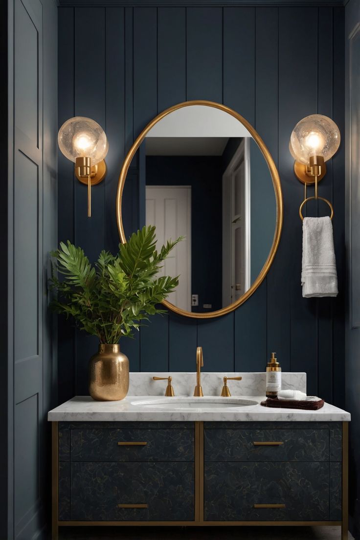 a bathroom with blue walls, gold fixtures and a large round mirror above the sink