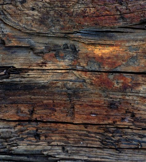 an old wooden wall with peeling paint on it