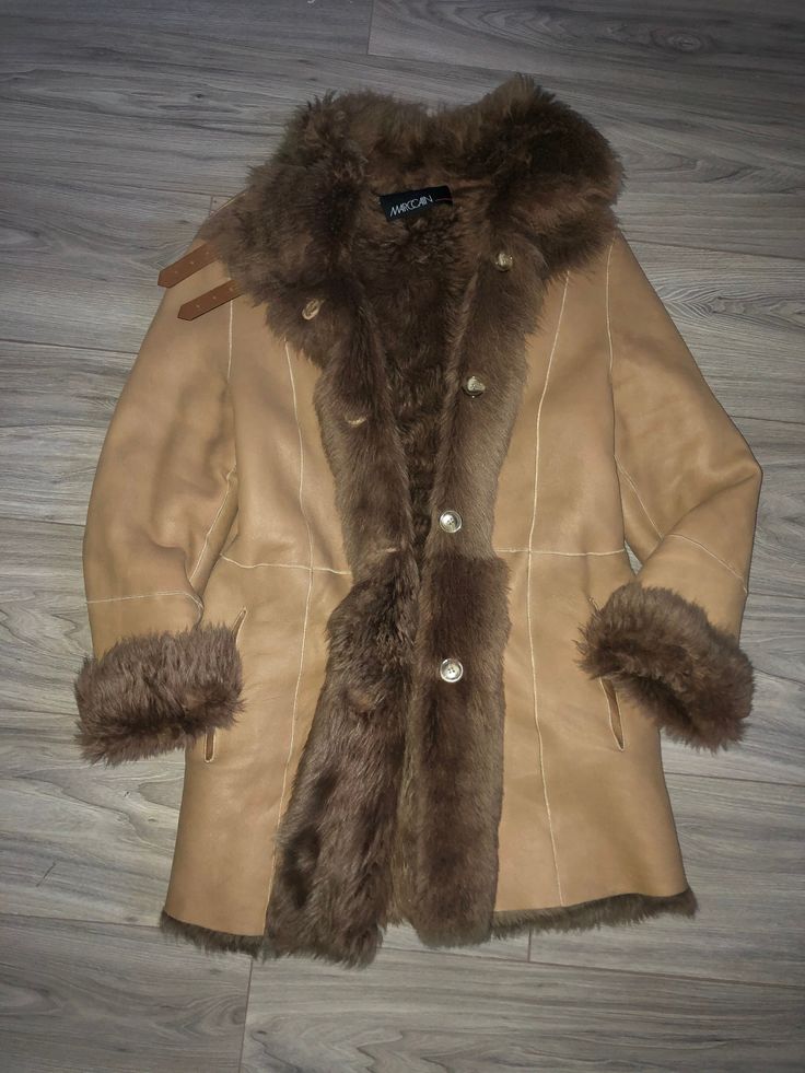 Very beautiful Tan leather shearling coat can be worn both sides, as a fur coat or leather coat with fur lining. High quality shearling, lightweight coat. Marc Cain Size N2, best fit sizes S/M chest 50cmx2, length 80cm, sleeve when unrolled 62cm Very good condition! Shearling Long Fur Coat For Cold Weather, Long Shearling Fur Coat For Cold Weather, Shearling Long Coat For Cold Weather, Brown Sheepskin Long Coat, Brown Sheepskin Outerwear With Faux Fur Trim, Sheepskin Long Fur Coat For Cold Weather, Sheepskin Long Coat For Cold Weather, Sheepskin Long Coat In Mink Color, Long Sheepskin Coat In Mink Color