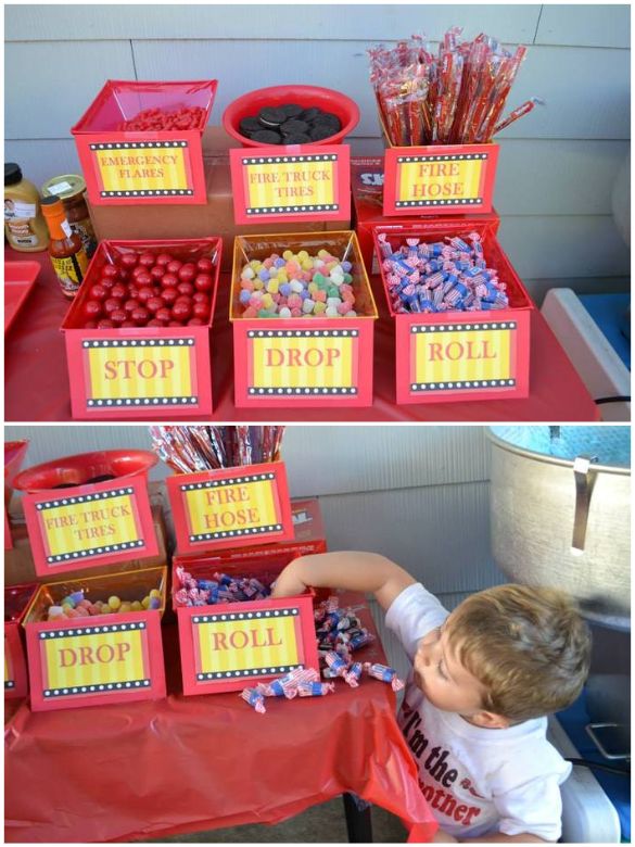 a little boy that is standing in front of a table with some candies on it