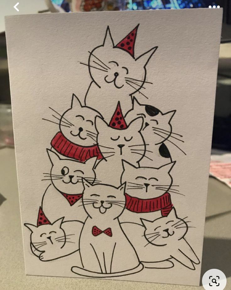 a card with a drawing of cats wearing hats and scarves on it's face