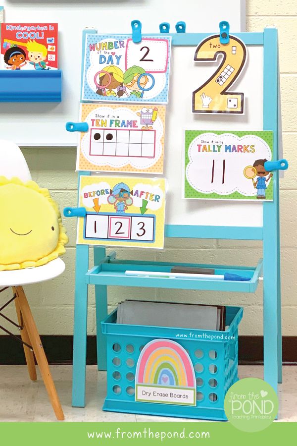 a child's desk with an easer, chair and calendars on it