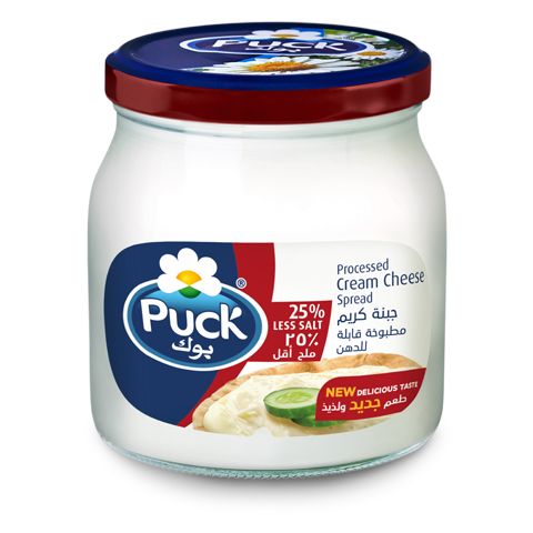 a jar of pick cream cheese spread with cucumber and tomato on the side