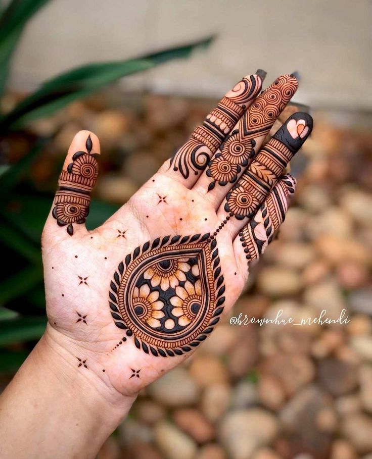 the hand is decorated with henna designs on it