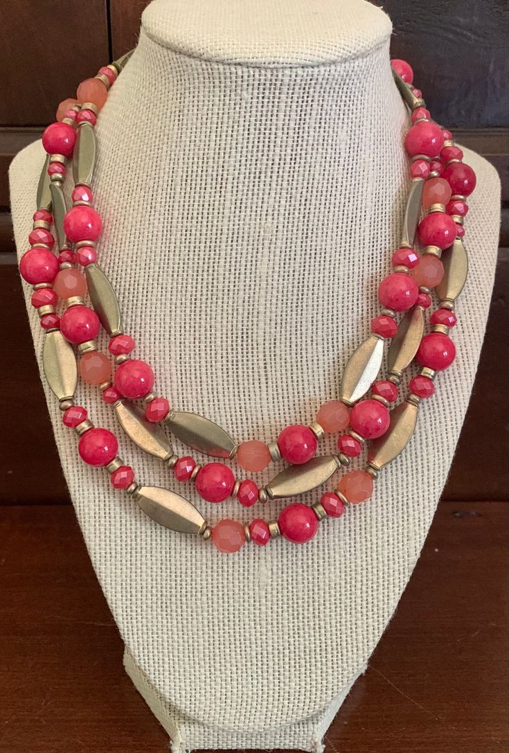 Premier Designs Coral/Pink Glass Bead and Gold Metal Bead Three Strand Choker Necklace.  Adjustable Length 16-20 Inches Long. In Good Condition with Premier Design Hangtag. Pink Beaded Necklaces With Round Beads, Pink Beaded Necklace With Round Beads, Pink Multi-strand Large Beads, Adjustable Pink Beaded Necklaces With Colorful Beads, Adjustable Pink Beaded Necklace, Pink Beaded Necklaces With Spacer Beads For Gifts, Pink Multi-strand Faceted Beads Jewelry, Pink Beaded Necklaces With Oval Beads, Elegant Pink Beaded Necklaces With Oval Beads