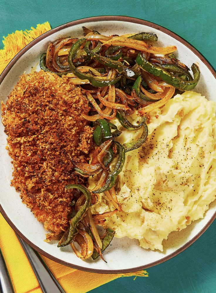 a white plate topped with mashed potatoes and green beans