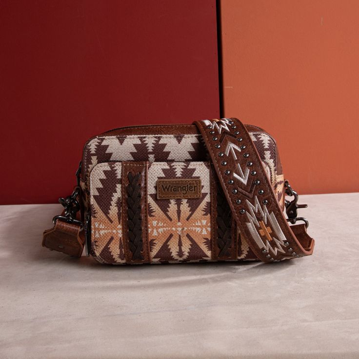 Made of synthetic leather and canvas Aztec pattern with whipstitch detail Top zipper closure Dual zippered compartment The bag includes zippered pockets and card slots Accented with concho and silvers on the strap Detachable and adjustable Aztec printed crossbody strap 8.2"(L) x 3"(W) x 6"(H) (Drop: 26.5") Interior Capacity: Small Mexican Fits, Country Bags, Background Country, Western Bags, Montana West Purse, Stylish Leather Bags, Fanny Pack Fashion, Best Crossbody Bags, Aztec Style