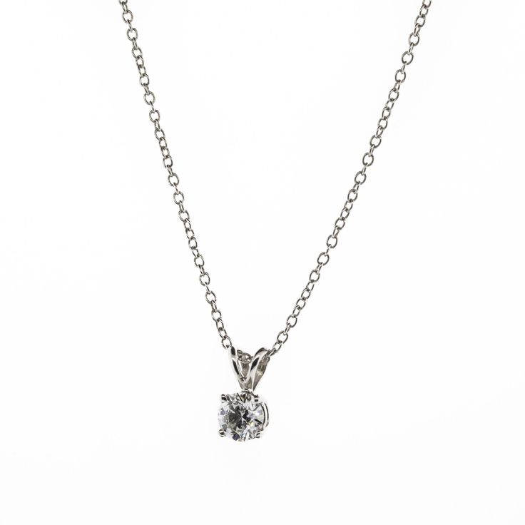 There's something classic and luxurious about a high quality single diamond hanging around your neck. This diamond solitaire pendant necklace is made from solid platinum and measures 18" long. The diamond is GIA certified as an all-natural .92ct G/VS2 round brilliant cut diamond securely set in a four prong basket style setting. This necklace comes with the GIA certificate and a free official appraisal showing the value of the necklace at $9650. Classic Platinum Silver Necklace, Classic Silver Platinum Necklace, Classic Diamond Round Pendant Necklace, Timeless Solitaire Pendant Necklace With Brilliant Cut, Timeless Solitaire Pendant Necklace In Brilliant Cut, Timeless Solitaire Necklace With Brilliant Cut Pendant, Classic Silver Diamond Necklace With Prong Setting, Platinum Solitaire Necklace With Round Diamond Pendant, Silver Solitaire Necklace With Prong Setting In Round Pendant