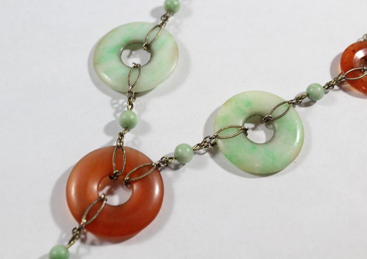 -Antique Chinese Sterling Silver Disk Natural Carnelian with Jadeite Necklace -Total length: 15.5 in -Small disk carnelian size:about 17.75 mm -Jadeite disk & big carnelian disk size: 25 mm -Jadeite pendant size: 21 mm x 13 mm x 3.4 mm (thickness) -Small jadeite bead size:about 5 mm -Total weight: 18.5 g -Marked sterling Green Multi-stone Round Necklace, Green Multi-stone Round Necklaces, Vintage Jade Necklace With Natural Stones, Vintage Natural Stones Gemstones, Vintage Round Natural Gemstones, Coral Earrings, New City, Earrings Photo, Belly Button Rings