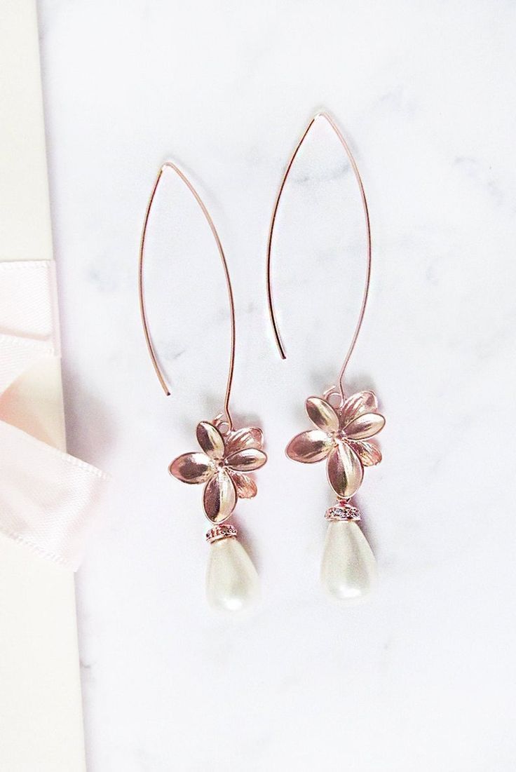 Rose gold pearl earrings long. These  rose gold dangle earrings are the perfect finish to your wedding look. #rosegoldpearlearrings Rose Gold Pearl Drop Flower Earrings, Rose Gold Flower Drop Earrings With Pearl, Rose Gold Dangle Pearl Party Earrings, Rose Gold Dangle Pearl Earrings For Party, Elegant Rose Gold Teardrop Earrings, Rose Gold Dangle Pearl Earrings, Rose Gold Drop Flower Earrings For Formal Events, Elegant Rose Gold Teardrop Pearl Earrings, Rose Gold Drop Earrings For Formal Occasions