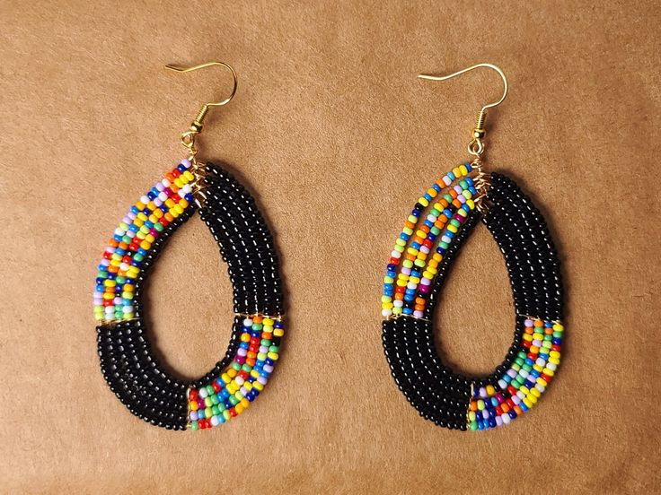 Multicolored earrings made from beaded wire.  Thanks for shopping! Black Beaded Teardrop Earrings, Black Jewelry With Colorful Oval Beads, Black Beads Teardrop Earrings, Black Hoop Earrings With Colorful Beads As Gift, Gift Black Hoop Earrings With Colorful Beads, Black Hoop Earrings With Colorful Beads For Gift, Adjustable Multicolor Beaded Teardrop Earrings, Adjustable Teardrop Beaded Earrings With Black Beads, Multicolor Teardrop Hoop Earrings With Dangling Beads