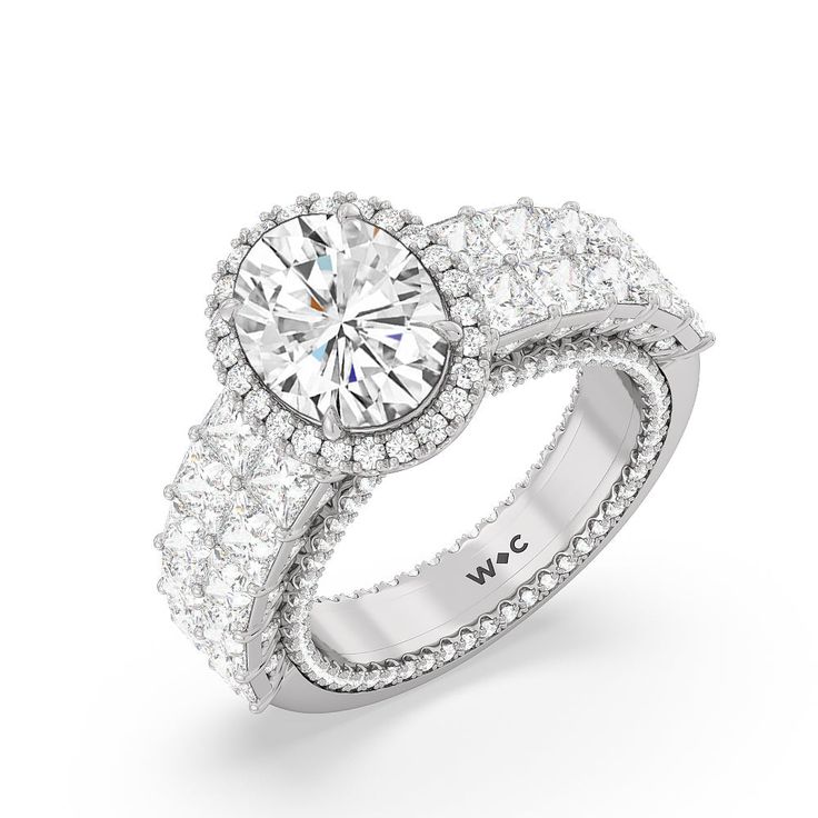 a white gold ring with two rows of diamonds on the band and an oval shaped center stone