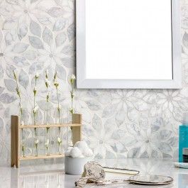 a bathroom vanity with a mirror and vase on the counter next to an empty frame