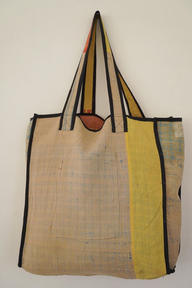 This bag is made from a vintage hand-stitched Kantha quilt. We make only 1-2 bags from each quilt and every one of them is one of a kind! Details: Shell fabric- Vintage Quilted Cotton Kantha 1. width (cm) - 40 2. height (cm)- 45 3. depth (cm) - 45 4. weight (g)- 0.400 kg 5. length of the shoulder (cm) -40 cm Care instructions: Dry clean or Hand-wash in warm water. Drip dry. How it's made: Kantha quilts are made using numerous layers of recycled silk or cotton saris which are hand-stitched in the Everyday Hand-stitched Rectangular Shoulder Bag, Everyday Rectangular Shoulder Bag With Hand-stitched Details, Everyday Rectangular Hand-stitched Shoulder Bag, Vintage Rectangular Shoulder Bag With Pockets, Hand-stitched Tote Bag For Everyday Use, Beige Patchwork Shoulder Bag For Everyday, Everyday Beige Patchwork Bags, Upcycled Everyday Rectangular Shoulder Bag, Everyday Upcycled Rectangular Shoulder Bag