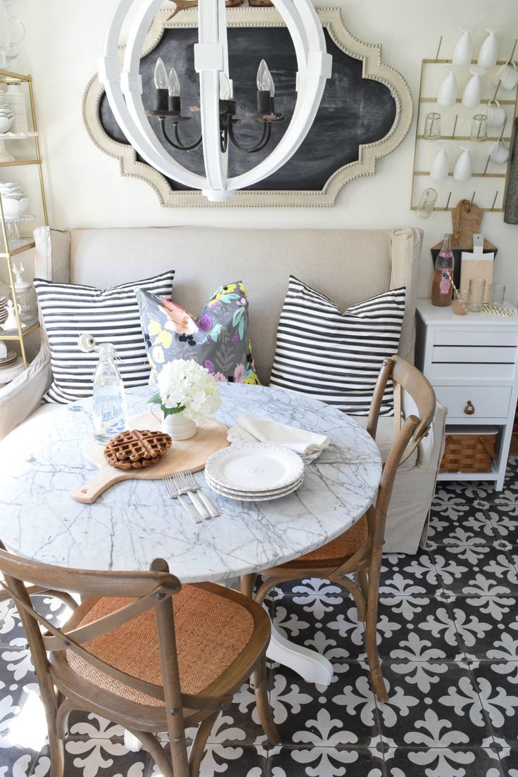 a dining room table with plates and bowls on it