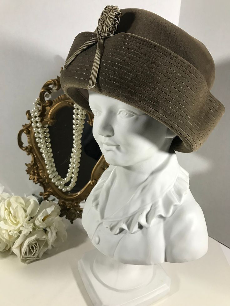 "Vintage 60s Lucila Mendez velvet hat, Vintage1960s Lucila Mendez velvet pillbox hat, Vintage accessories, vintage unique hat, dress hat.  This hat is a neutral taupe color made of velvet with braided ribbon front detail. Height 4.5\" Inside circumference 22\"" Vintage Wide Brim Costume Hat For Evening, Vintage Fedora Costume Hats For Party, Vintage Brimmed Felt Hat For Party, Vintage Wide Brim Felt Hat For Party, Vintage Wide Brim Top Hat For Evening, Vintage Cloche Costume Hat For Party, Vintage Cloche Party Hat, Vintage Fedora Hat For Evening, Vintage Fedora For Evening Wear