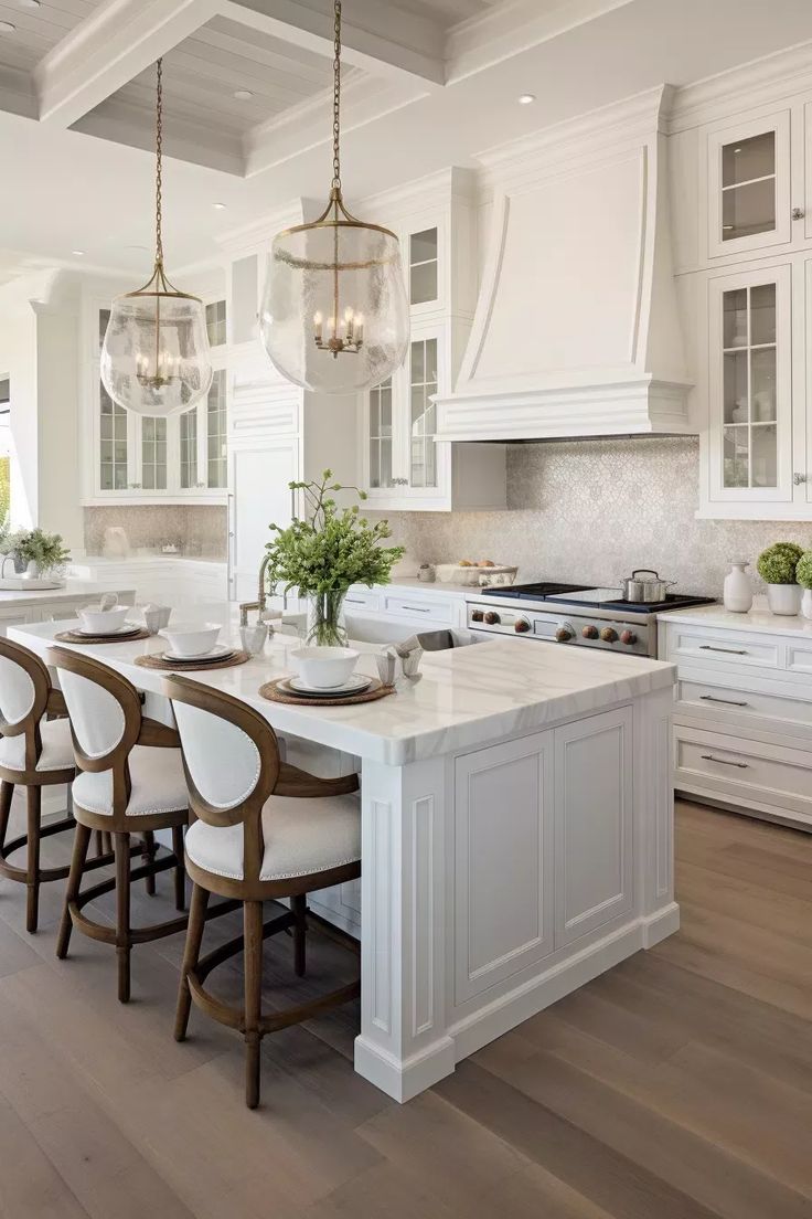 a large kitchen with white cabinets and wooden flooring, along with an island in the middle