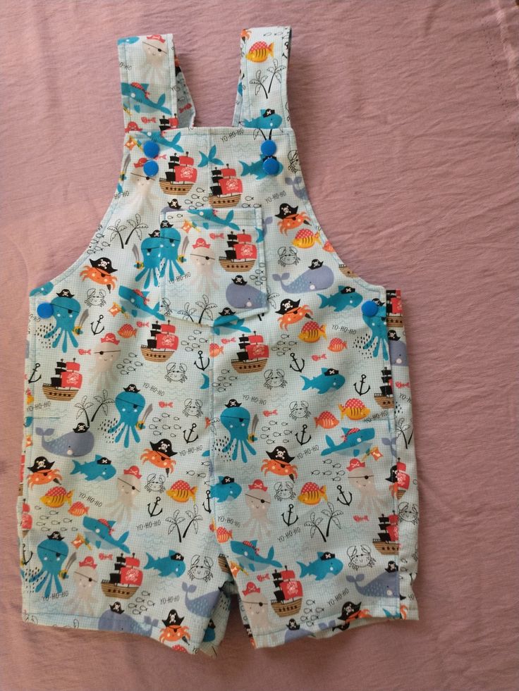 These sea creature overalls are the perfect outfit for a summertime play date, outing, photo shoot and more! These overalls feature kam snaps for adjustable straps as well as easy changing time. Made with 100% cotton, making them lightweight and comfortable for your little one. Cotton Overalls With Adjustable Straps For Beach, Summer Shortalls For Beach, Summer Beach Shortalls Overall, Summer Beach Shortalls, Beach Style Summer Shortalls, Playful Overalls With Pockets For Playtime, Cute Summer Jumpsuits And Rompers With Bib Front, Cute Bib Front Jumpsuits And Rompers For Summer, Cute Jumpsuits And Rompers With Pockets For Playtime