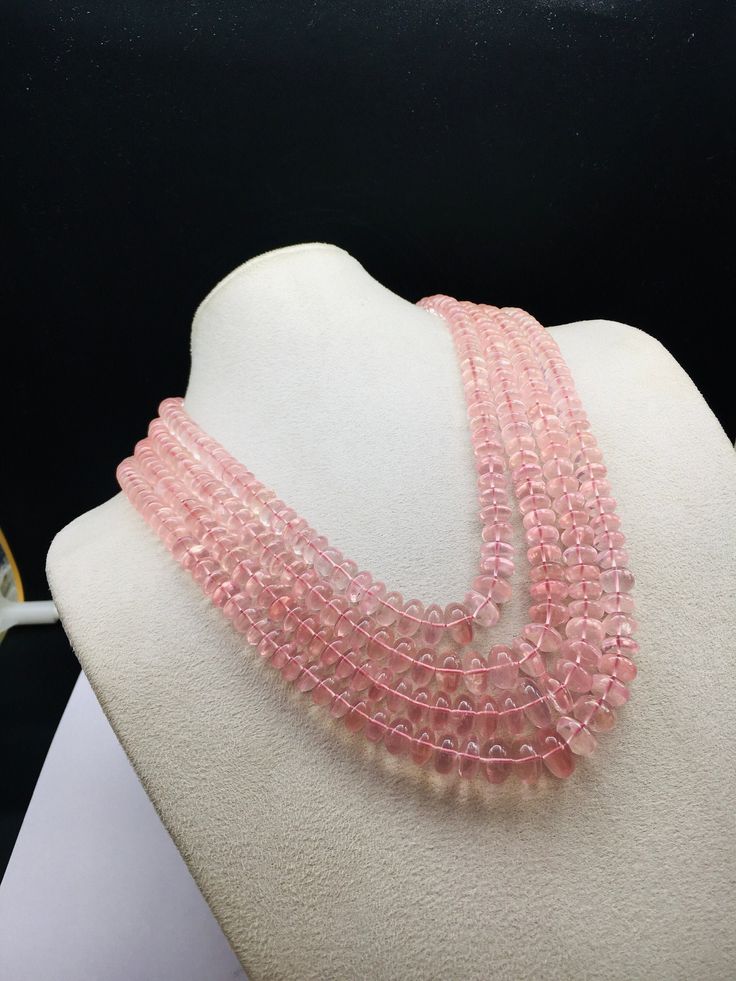 100% Natural Rose Quartz smooth rondelle shape beaded necklace with adjustable silk cord closure. Details: - Gemstone - Rose Quartz Shape - Rondelle Gross weight - 1073.75 carat Net weight - 1033.00 carat Length - Inner - 15 inches, Outer - 19 inches Calibration of beads - 8.00 millimeters till 14.00 millimeters SKU - HJSPSAR0033 100% NATURAL ROSE QUARTZ AMAZING NECKLACE UNIQUE NECKLACE PINK COLOR NECKLACE Thank you for your kind visit to my shop. NOTE: - You will receive the same product you se Elegant Pink Faceted Crystal Necklace, Elegant Round Pink Crystal Necklace, Pink Polished Rondelle Beads Jewelry, Pink Rondelle Jewelry With Polished Beads, Pink Rondelle Polished Beads Jewelry, Pink Faceted Round Bead Necklaces, Pink Faceted Round Beaded Necklaces, Faceted Pink Beaded Necklaces, Pink Round Gemstone Beaded Necklace