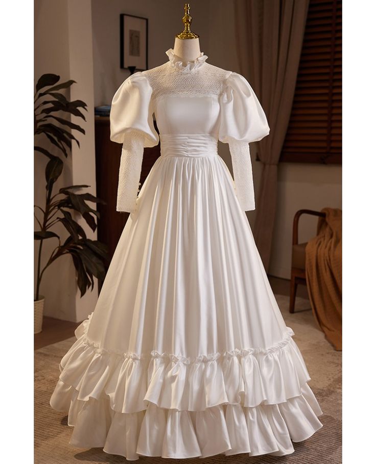 Get 10% off now! Buy vintage inspired bubble long sleeved satin wedding dress with collar at wholesale price online. Free shipping and pro custom service since 2009. Medieval Clothing Wedding Dress, Puff White Dress, Luxury Victorian Dress With Ruffles In Satin, Wedding Dress Peter Pan Collar, Luxury Vintage Dresses For Cosplay, Luxury White Elegant Victorian Dress, Luxury Ruffled Vintage Dress For Vintage Events, Victorian Wedding Dress Veaul, Luxury Victorian Satin Dress With Ruffles