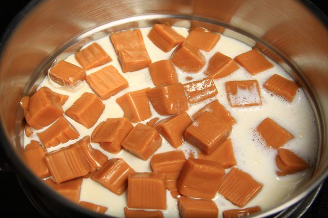 a pan filled with milk and caramel cubes