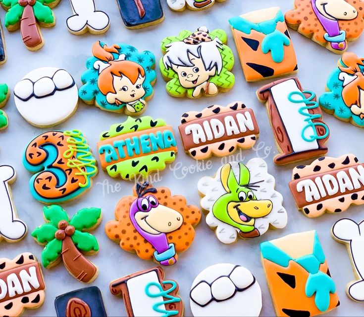 decorated cookies are displayed on a table for children's birthdays and special occasions