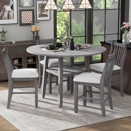 a dining room table with four chairs around it