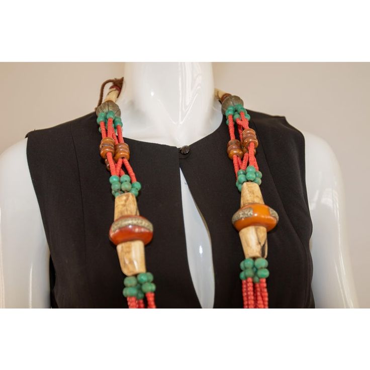 Stunning vintage Moroccan hand crafted, vibrantly colored Berber tribal faux amber resin wedding necklace.   Striking Amazigh (Berber) wedding necklace comprising faux coral, amazonite, with old animal-horn and faux amber from the Atlas Mountains, along with traditional Tuareg and Berber beads, red faux coral, turquoise, hand rolled ceramic beads, engraved Berber silver., resin beads, small silver beads, horn and additional beads in rich turquoise blue, and yellow amber is characteristic of Berb Traditional Amber Jewelry With Carved Details, Bohemian Carved Round Beads Jewelry, Adjustable Bohemian Red Coral Necklace, Bohemian Hand-strung Red Coral Necklaces, Traditional Adjustable Red Coral Jewelry, Artisan Red Coral Beaded Necklaces, Bohemian Brown Ceremonial Jewelry, Orange Handmade Jewelry For Ceremonial Use, Unique Hand-strung Red Coral Necklaces