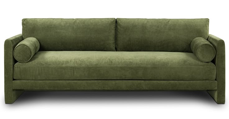 a green couch sitting on top of a white floor