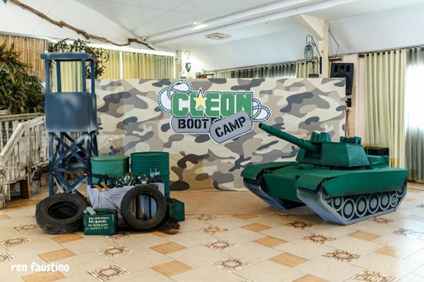 an army tank and other items are on display in a room with tile flooring