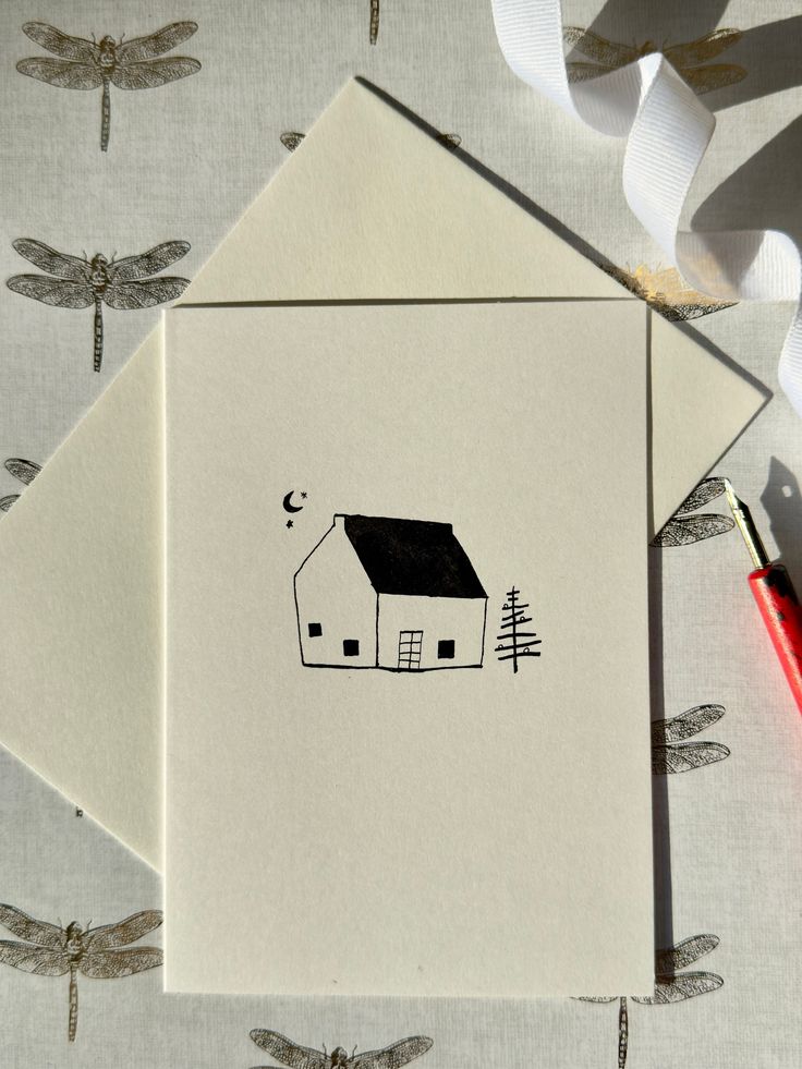 a card with a house and dragonflies on it