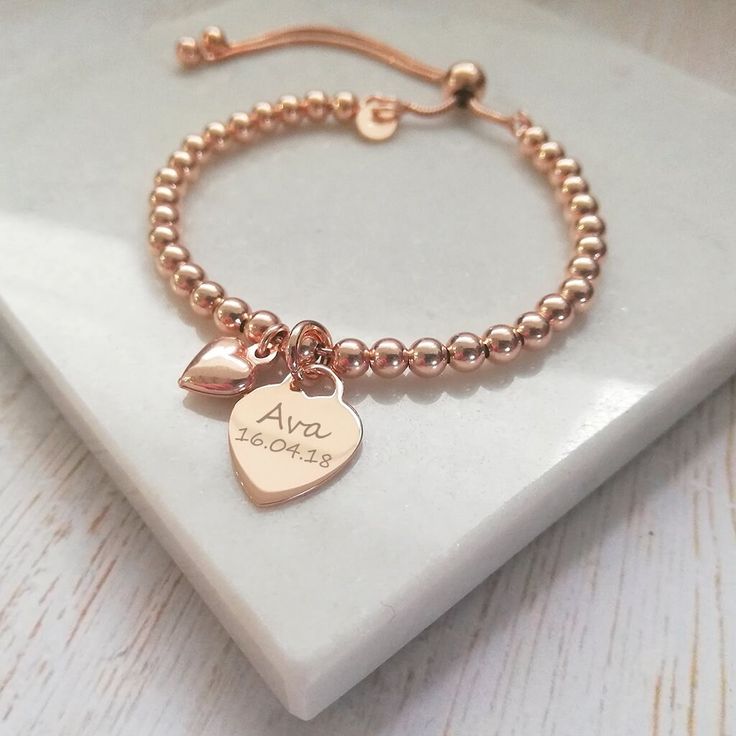 "Wear your heart on your sleeve quite literally with our beautiful slider bracelets! This beautiful rose gold bracelet combines a rose gold heart charm, perfect for engraving a name or special date, alongside a dinky rose gold puffed heart charm. The rose gold vermeil heart charm measures 12mm across the front of the heart and sits centrally on a rose gold vermeil ball slider bracelet crafted with dainty 4mm rose gold beads. The dinky rose gold vermeil heart charm measures 10x8mm and has been de Adjustable Rose Gold Jewelry With Heart Charm, Adjustable Rose Gold Heart Bracelet For Valentine's Day, Rose Gold Name Bracelet For Friendship On Mother's Day, Rose Gold Name Bracelet For Mother's Day Friendship Gift, Adjustable Rose Gold Charm Bracelet With Heart Charm, Personalized Rose Gold Name Bracelet For Friendship, Adjustable Rose Gold Heart Bracelet For Friendship, Adjustable Rose Gold Charm Bracelet For Friendship, Rose Gold Heart Charm Bracelet For Friendship