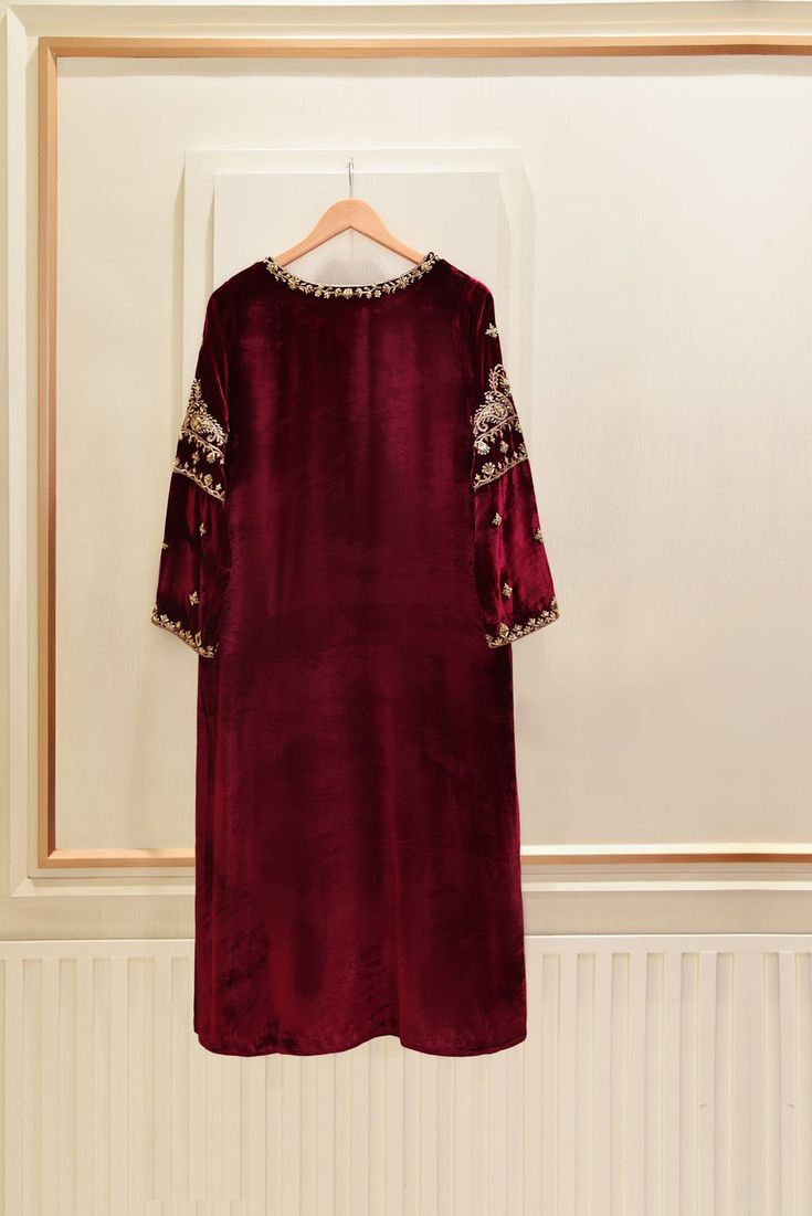 A heavily embellished beautiful three piece on pure burgundy velvet, adorned with the most stunning hand/ada work of dabka, naqshi, sequins and crystals done by our skilled artisans. Paired with a matching pure velvet shawl and flappers featuring intricate hand details. The length of the long Kameez is 48 inches. Agha Anarkali Velvet Lehenga With Dabka Work, Elegant Red Unstitched Suit With Dabka, Formal Hand Embellished Anarkali Dupatta, Formal Sharara With Dabka On Jamawar Fabric, Formal Anarkali Hand Embellished Dupatta, Formal Sharara With Dabka On Jamawar, Formal Jamawar Sharara With Dabka Detailing, Unstitched Velvet Anarkali Set For Wedding, Wedding Velvet Sets With Dabka Work