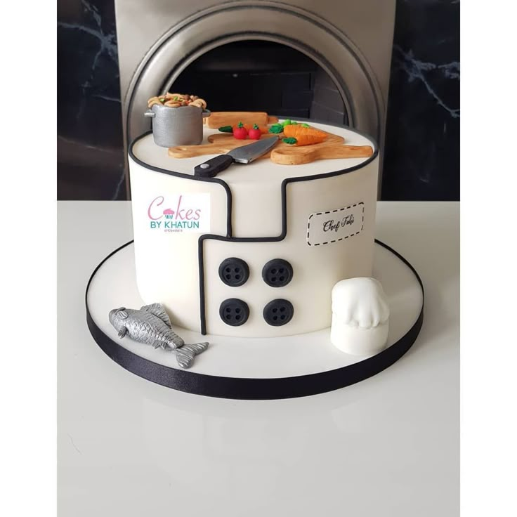 a cake that is shaped like a stove with food on top and cooking utensils