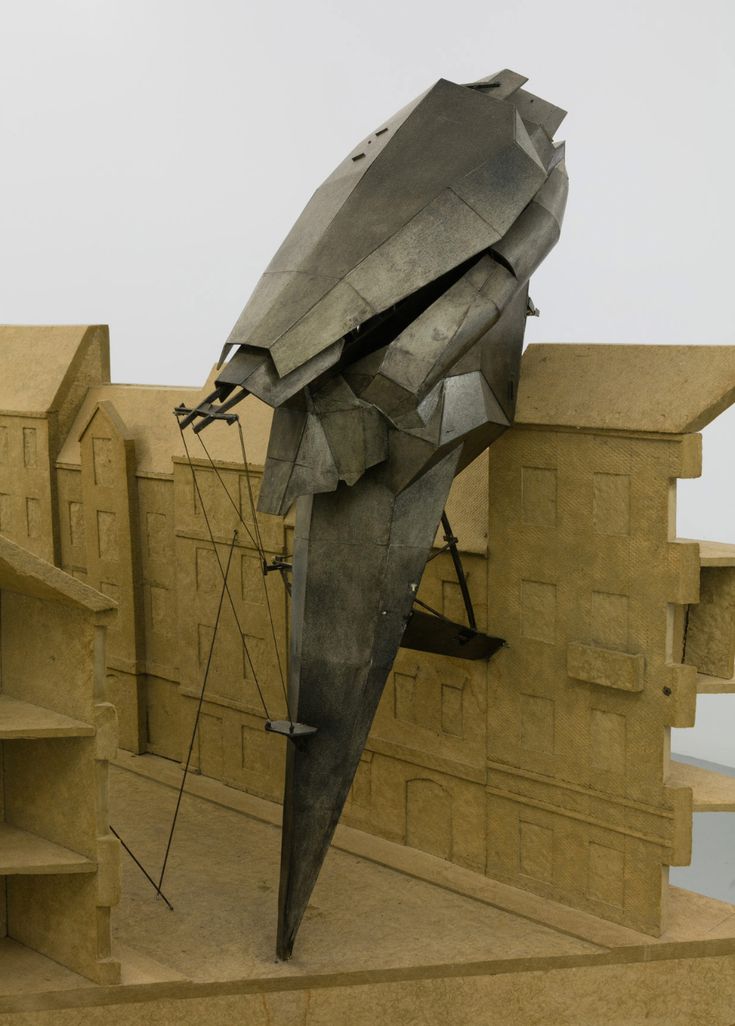 a large metal object sitting on top of a cement wall next to stairs and steps