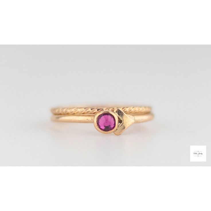 This beautiful set of elegant, handmade stacking rings feature a shimmering fuchsia (dark pink, magenta) colored cubic zirconia stone set in a gold filled bezel atop two gold-filled textured ring bands. The deep, sparkling color of the dark pink fuchsia pink cubic zirconia pairs perfectly with the bright gold lending a royal color combination and timeless beauty to the rings. US size 6, EU size 51.5: inside circumference is 2.04 inches, 51.9mm Pink Stackable Birthstone Promise Ring, Pink Gold Stackable Rings Fine Jewelry, Pink Gold Stackable Fine Jewelry Rings, Pink Gold Stackable Rings In Fine Jewelry Style, Pink Stackable Rings With Ethical Gemstones As Gift, Elegant Pink Sapphire Stackable Ring, Pink Ruby Stackable Jewelry, Fine Jewelry Gold Crystal Ring With Ruby, Pink Ring With Bezel Setting