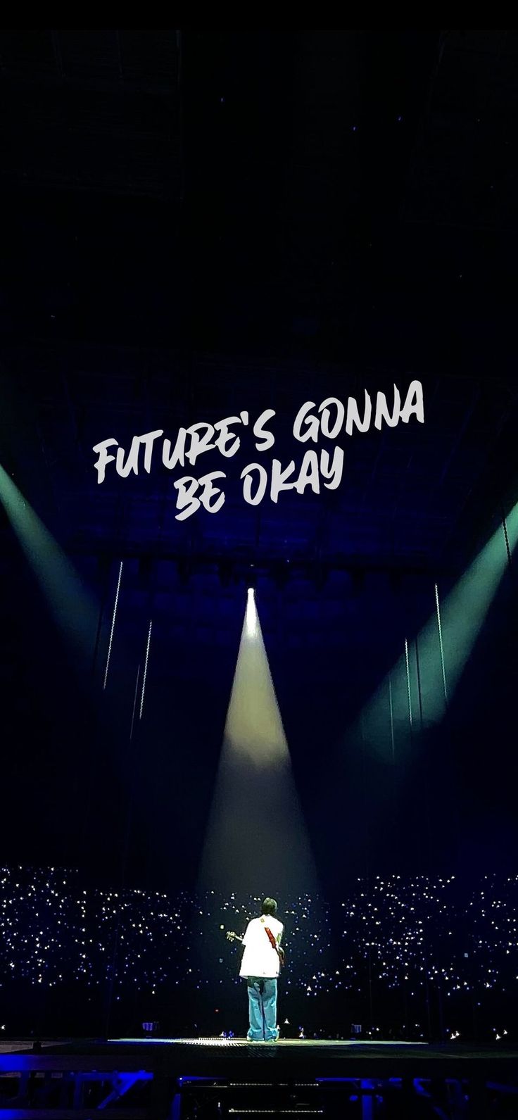 a man standing on top of a stage in front of a large sign that says future's guinea be okay